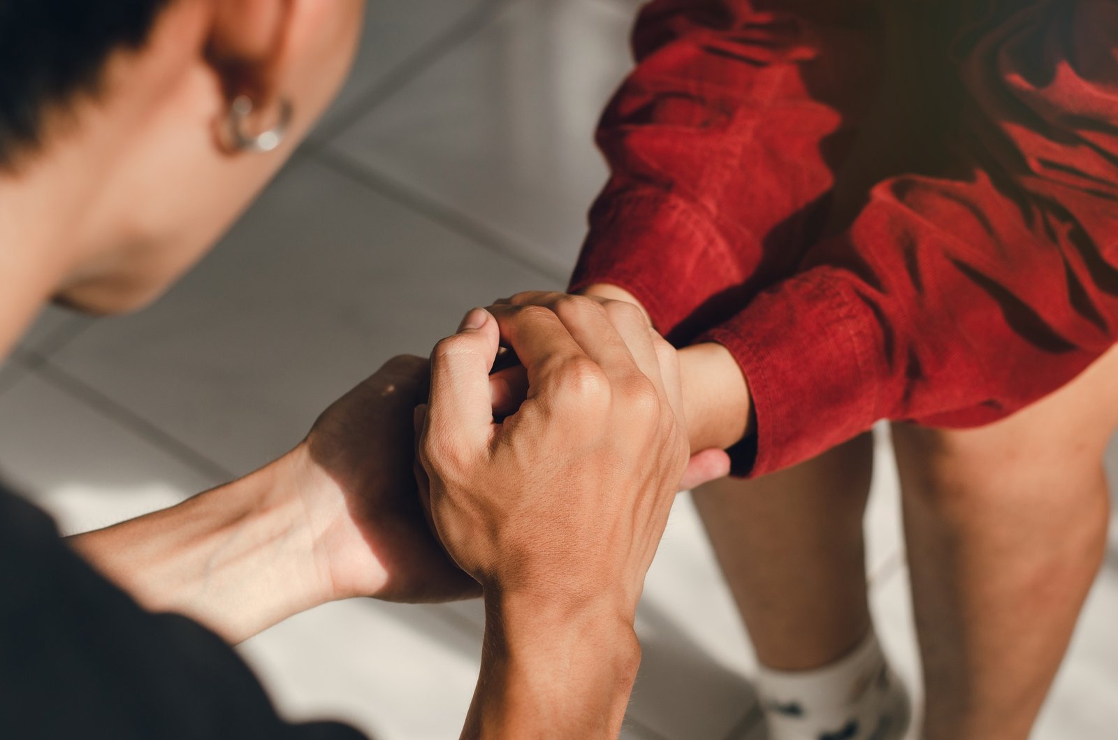 couple holding hands and praying together with humility in the love of God